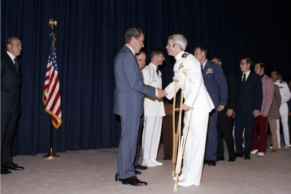 At a pre-dinner reception, US President Richard Nixon (1913 - 1994) shakes hands greets former North Vietnamese prisoner of war Lieutenant Commander John McCain, in Washington DC, on May 24, 1973.