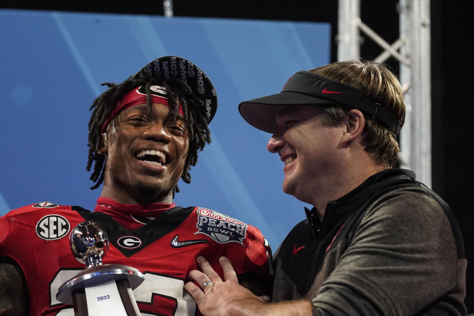 Devensive player of the game Georgia defensive back Javon Bullard celebrates with Georgia head coach Kirby Smart after the Peach Bowl NCAA college football semifinal playoff game between Georgia and Ohio State, Sunday, Jan. 1, 2023, in Atlanta. Georgia won 42-41. (AP Photo/Brynn Anderson)