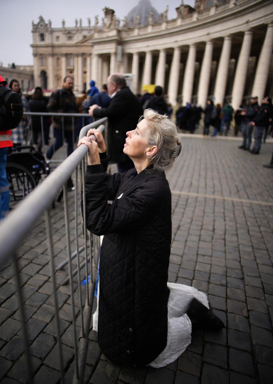 A woman attends the funeral mass for late Pope Emeritus Benedict XVI in St. Peter's Square at the Vatican, Thursday, Jan. 5, 2023. Benedict died at 95 on Dec. 31 in the monastery on the Vatican grounds where he had spent nearly all of his decade in retirement. (AP Photo/Domenico Stinellis)