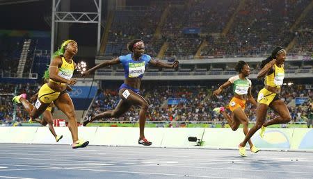 2016 Rio Olympics - Athletics - Final - Women's 100m Final - Olympic Stadium - Rio de Janeiro, Brazil - 13/08/2016. Elaine Thompson (JAM) of Jamaica (R) crosses the finish line to win the women's 100m final. REUTERS/Kai Pfaffenbach