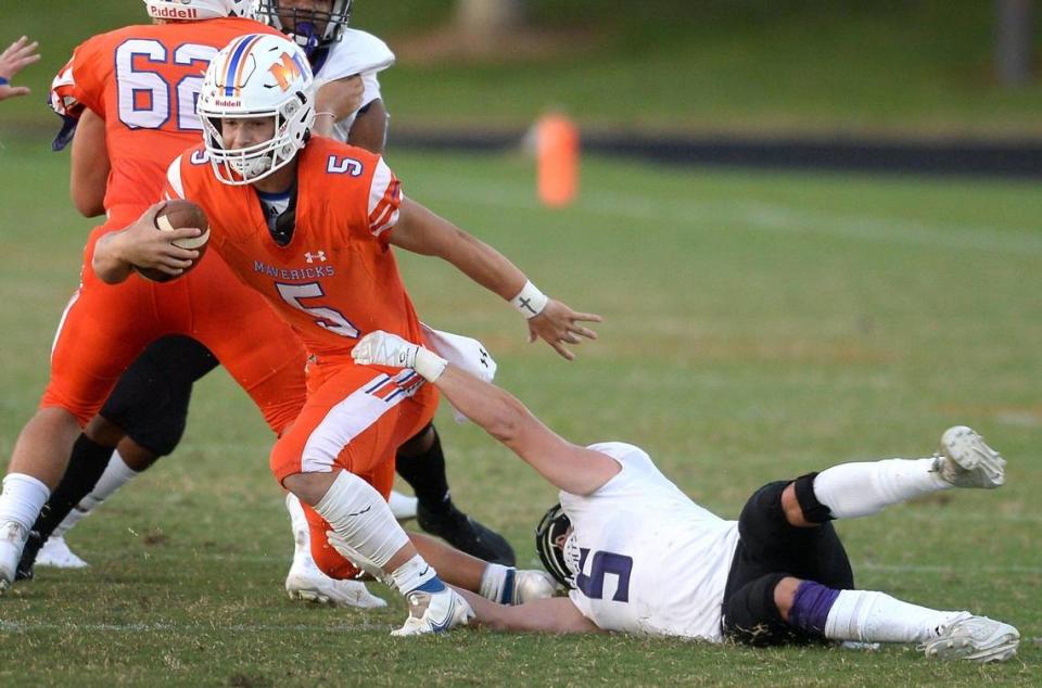 Ardrey Kell linebacker Blake Henninger, right, attempts to make a sack on Marvin Ridge quarterback Evan Medders, left, during first half action on Friday, September 3, 2021.