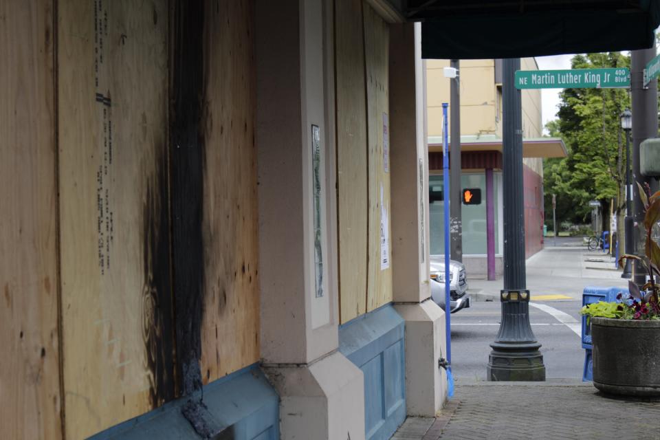 This Wednesday, July 1, 2020, photo shows damage from a recent fire set by demonstrators on the boarded-up windows of a hair products business that caters to African-American customers in a historically Black neighborhood in Portland, Ore. Thousands of protesters in the liberal and predominantly white city have taken to the streets peacefully every day for more than five weeks to decry police brutality, but recent violence by smaller groups is creating a deep schism in the protest movement. As demonstrations enter their second month, they have shifted to a historically Black neighborhood. (AP Photo/Gillian Flaccus)