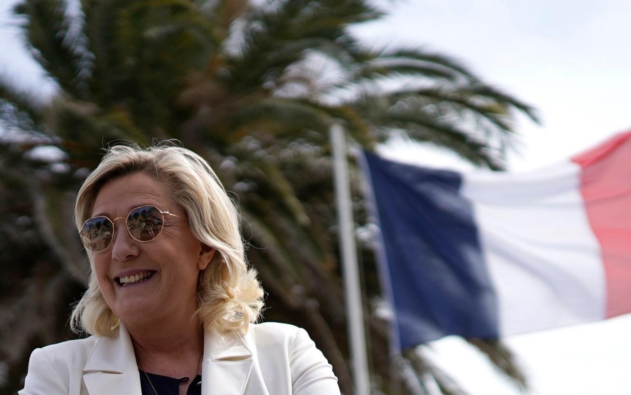 Far-right leader Marine le Pen smiles as he visits a divers school in Frejus