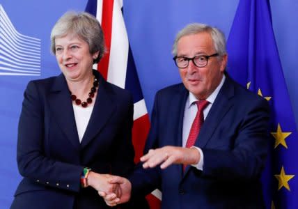 British Prime Minister Theresa May is welcomed by European Commission President Jean-Claude Juncker ahead of the European Union leaders summit in Brussels, Belgium October 17, 2018. REUTERS/Yves Herman