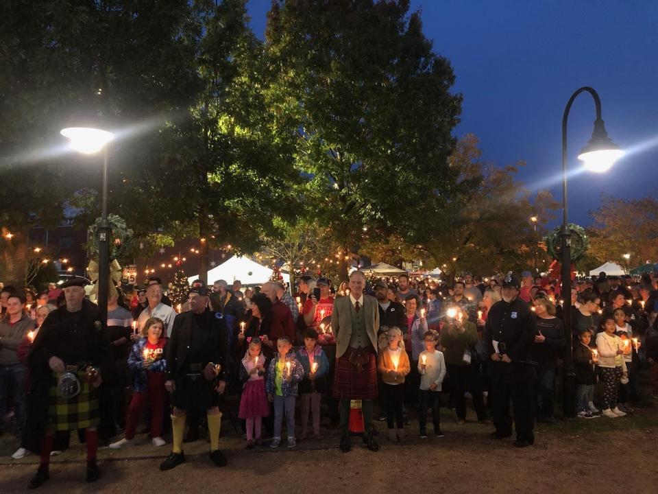 A candlelight procession takes place at A Dickens Holiday in downtown Fayetteville on Nov. 25, 2022.