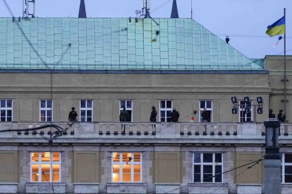 Police officers stand on the balcony of Philosophical Faculty of Charles University in downtown Prague, Czech Republic, Thursday, Dec. 21, 2023. Czech police say a shooting in downtown Prague has killed an unspecified number of people and wounded others. (AP Photo/Petr David Josek)