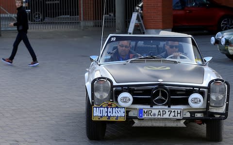 Andreas Pohl (R) and Robert Peil of Germany drive Mercedes 280 SL car of year 1970 during the Baltic Classic Rally 2017 stop in Riga, Latvia, in 2017 - Credit: INTS KALNINS/Reuters
