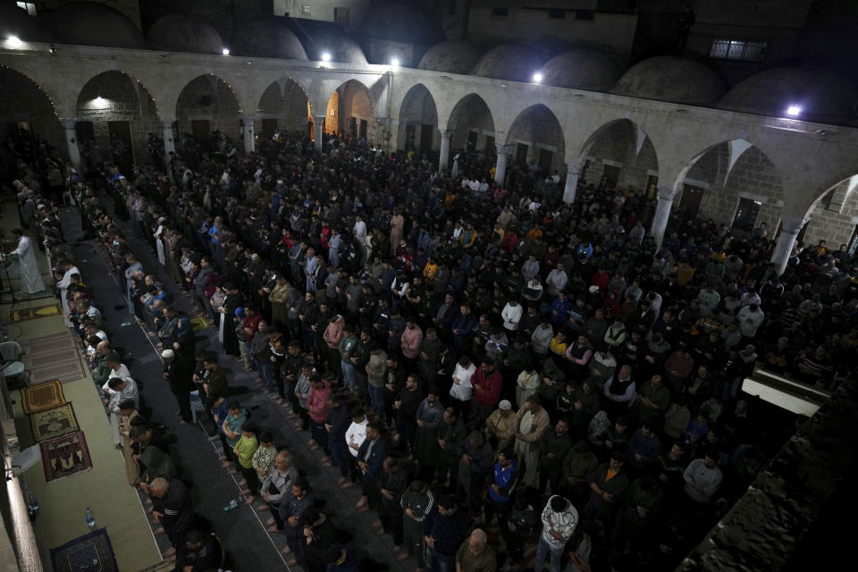 Palestinian Muslim worshippers pray during Laylat al-Qadr, also known as the Night of Destiny, at al Sayed Hashim mosque in Gaza City, early Tuesday, April 18, 2023. Laylat al-Qadr is marked on the 27th day of the holy fasting month of Ramadan and is commemorated as the night Prophet Muhammad received the first revelation of the Quran. Muslims traditionally spend the night in prayer and devotion. (AP Photo/Adel Hana)