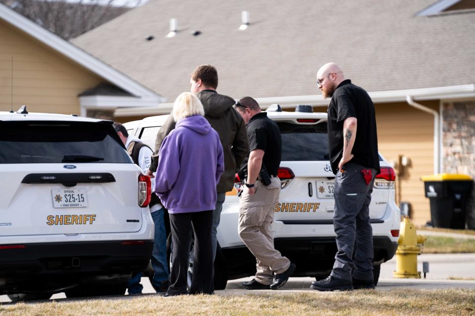 Kenneth Bensley and T.J. Wood, of the West Des Moines Police Department's crisis intervention team, arrive at a call to assist Dallas County sheriff officers Wednesday, Feb. 21, 2024, in Clive.