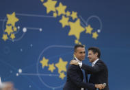 FILE - In this Sunday, Oct. 21, 2018 file photo, Vice Premier Luigi Di Maio, right, and Italian Premier Giuseppe Conte Hugh each other during a Five Stars Movement rally at Rome's Circus Maximus. When Giuseppe Conte exited the premier’s office, palace employees warmly applauded in him appreciation. But that’s hardly likely to be Conte’s last hurrah in politics. Just a few hours after the handover-ceremony to transfer power to Mario Draghi, the former European Central Bank chief now tasked with leading Italy in the pandemic, Conte dashed off a thank-you note to citizens that sounded more like an ’’arrivederci″ (see you again) then a retreat from the political world he was unexpectedly propelled into in 2018. (AP Photo/Gregorio Borgia, File)