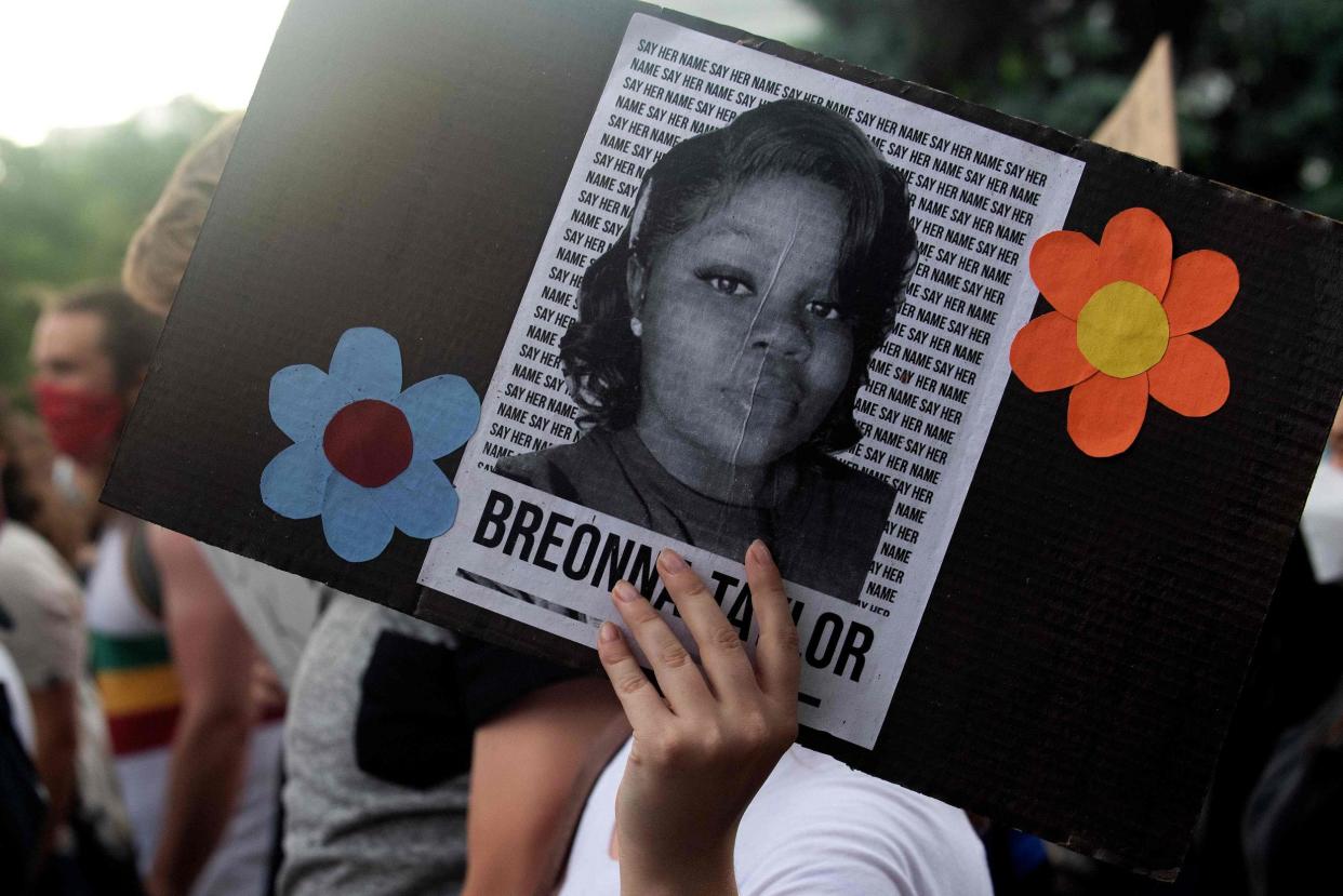 A demonstrator holds a sign with the image of Breonna Taylor, a black woman who was fatally shot by Louisville Metro Police Department officers, during a protest against the death George Floyd in Minneapolis, in Denver, Colorado on June 3, 2020: AFP / Jason Connolly