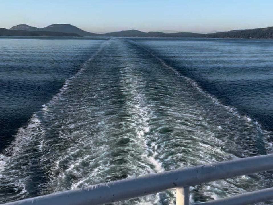 view of the ocean off the back of a ferry boat in motion