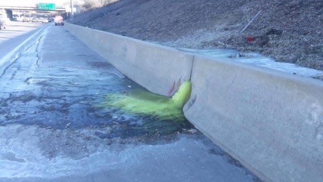 A greenish-yellow liquid flows through a retaining wall on I-696, triggering a lane closure Friday afternoon and hazmat cleanup Friday night, Dec. 20, 2019.