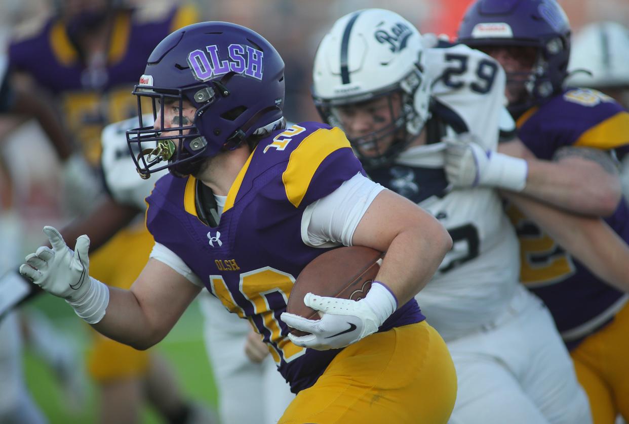 OLSH's Brady Brazell (10) sprints through a hole in the Rochester defensive line during the first half Saturday night at Moon Area High School.