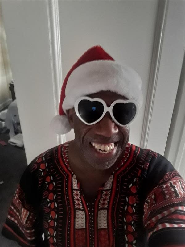 Tyree Leslie, 51, takes a Christmas selfie in his hotel room where he has been riding out the pandemic. Leslie, a teacher who works with students receiving special education services, has been experiencing homelessness about a year after losing his job and safety net.