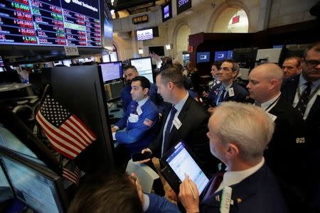 Traders work on the floor at the New York Stock Exchange (NYSE) in Manhattan, New York City, U.S., March 2, 2018. REUTERS/Andrew Kelly