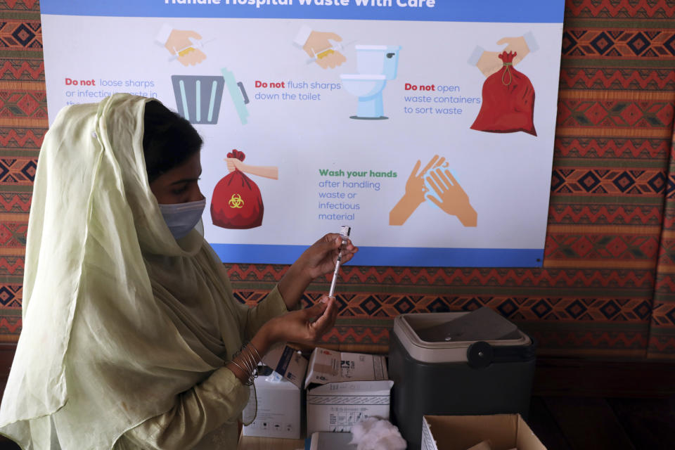 A health worker prepares a Pfizer COVID-19 vaccine at a vaccination center in Islamabad, Pakistan, Monday, Oct. 4, 2021. (AP Photo/Rahmat Gul)