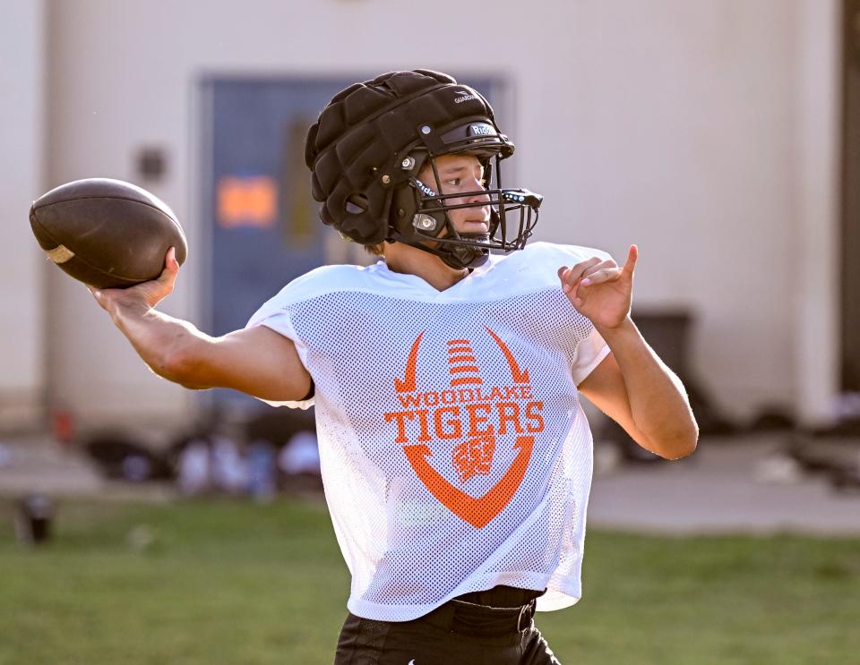 Woodlake quarterback Aldo Rodriguez passes during football practice on Monday, August 5, 2024.