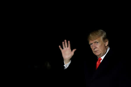 U.S. President Donald Trump waves as he walks on South Lawn of the White House upon his return to Washington, U.S., from France, November 11, 2018. REUTERS/Yuri Gripas