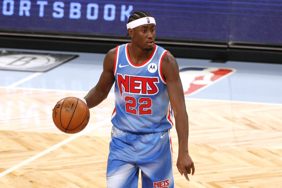 Caris LeVert dribbles the ball during a Nets game.