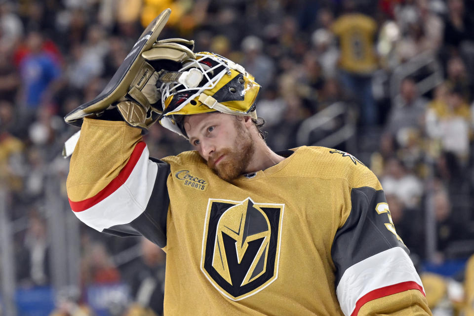 Vegas Golden Knights goaltender Laurent Brossoit adjusts his helmet during the third period of Game 5 of the team's NHL hockey Stanley Cup first-round playoff series against the Winnipeg Jets on Thursday, April 27, 2023, in Las Vegas. (AP Photo/David Becker)
