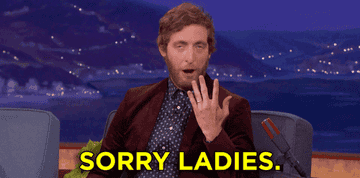 Thomas Middleditch on a talk show showing off his wedding band on his finger and saying "Sorry, ladies"