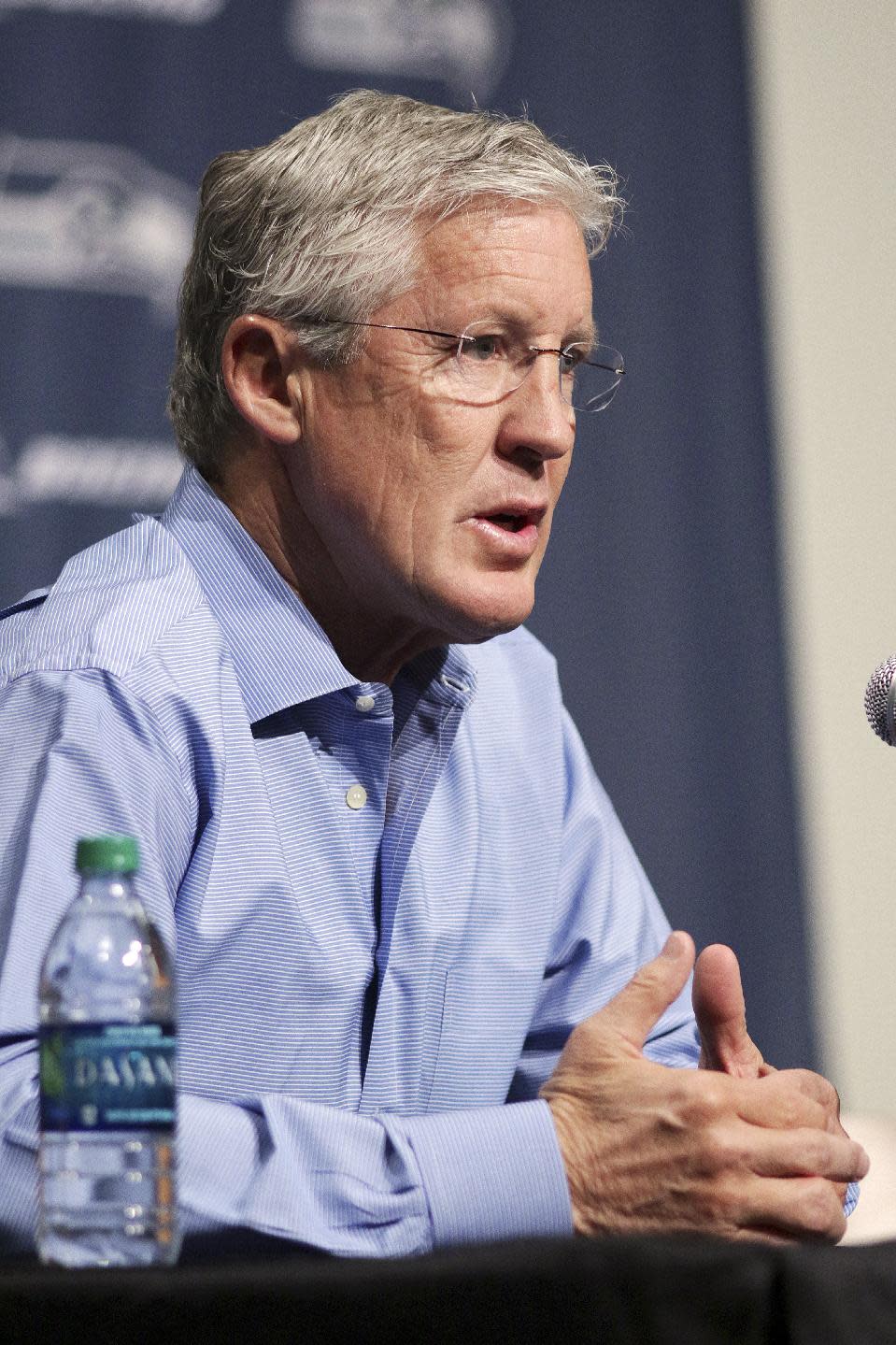 Seattle Seahawks NFL football head coach Pete Carroll talks to the media during a news conference Friday, April 4, 2014, in Renton, Wash. The Seahawks have locked up coach Carroll with a three-year contract extension after he led the franchise to its first Super Bowl title. (AP Photo/Marcus R. Donner)