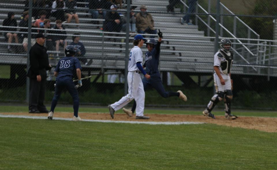 St. Thomas' Cade Murphy scores a run in the seventh inning as teammate Kenny Avery waits for him during Wednesday's Division II semifinal against Hollis-Brookline.