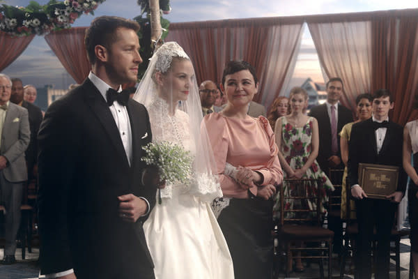 Emma Swan is walked down the aisle by Snow and Charming