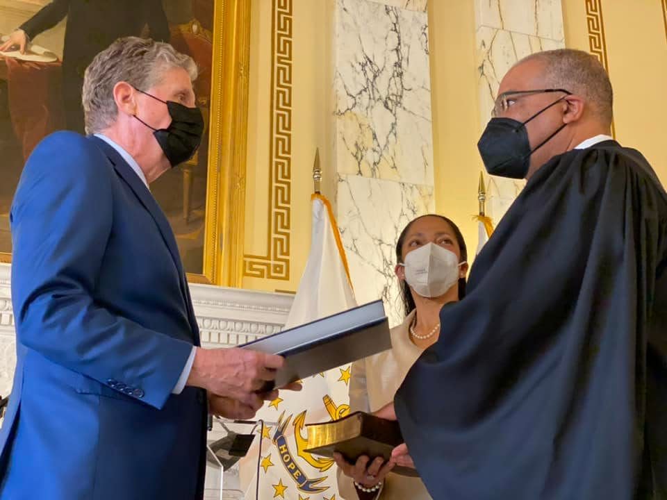 Gov. Dan McKee swears in William Trezvant as an associate judge of the Rhode Island District Court during a ceremony at the Statehouse on Jan. 10.