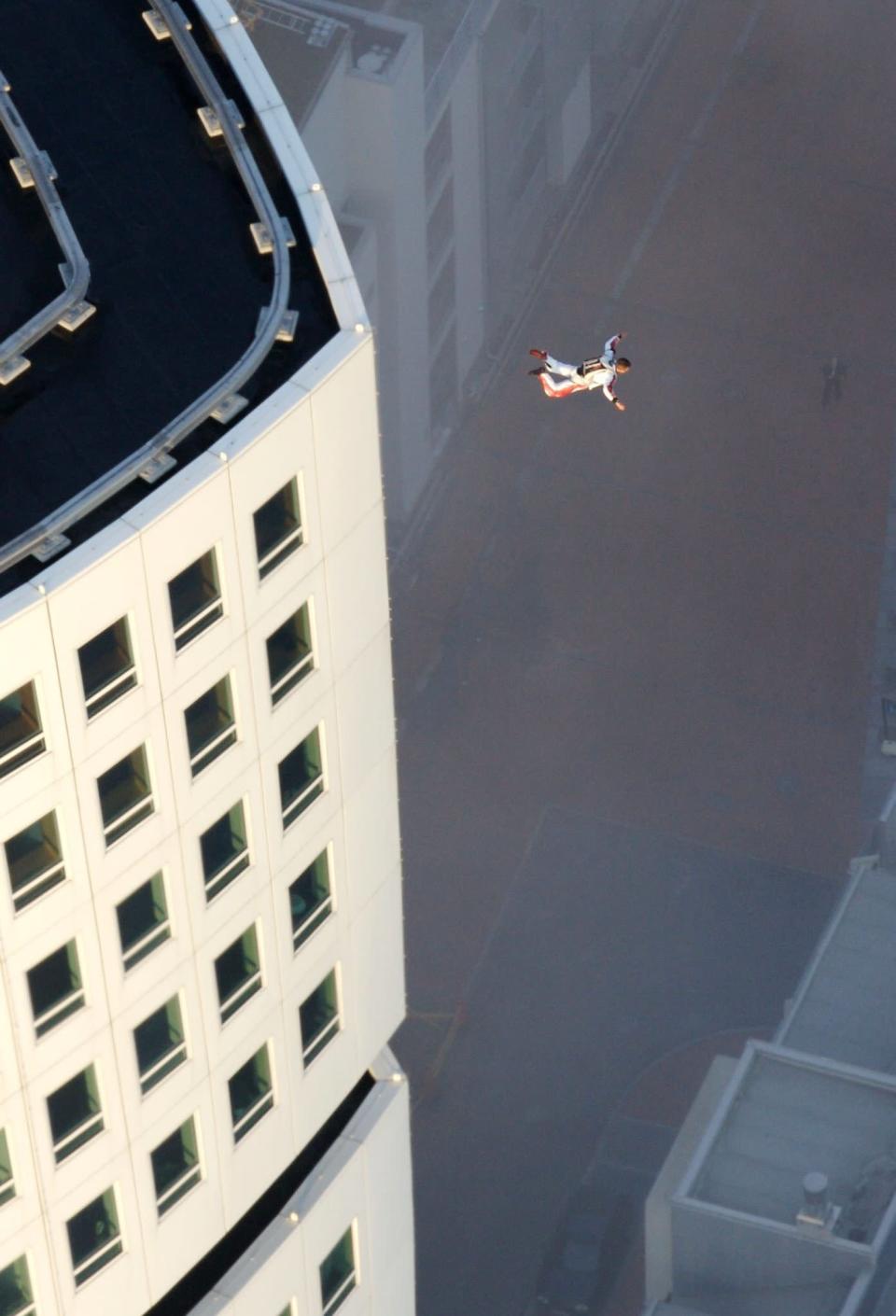 Extreme sportsman Felix Baumgartner jumps from Scandinavias highest residential building the Turning Torso in Malmo, Sweden, Friday, Aug. 18, 2006. Baumgartner had minutes earlier landed on top of the "Turning Torso" by parachute after jumping from a helicopter. After the illegal jump he escaped to Denmark in a boat. (AP Photos/Bernhard Spoettel/ho)