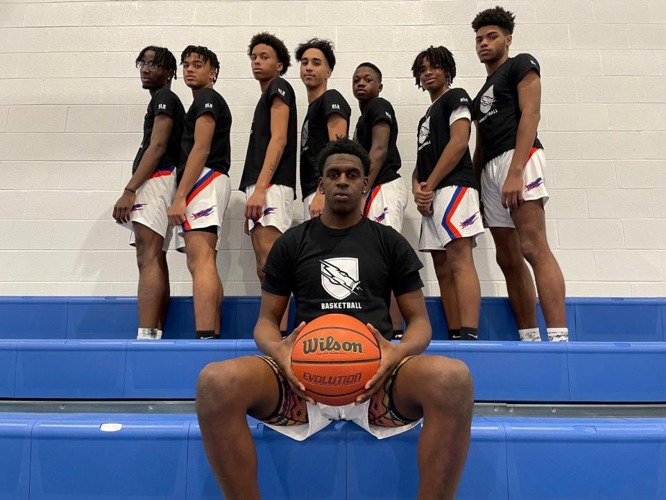 Millville senior Calem Bowman, sitting, is the captain of the boys' basketball program. Head coach wants his team to "BLB," as in "Be Like Bow." The acronym is on the sleeve of the team's new shirts. Standing (left to right): Kevin Rivera, Khalon Foster, Jabbar Barriento, Rafael Goyco, Raquan Ford, Donte Smith and Jaden Merrill.