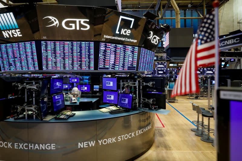 FILE PHOTO: A nearly empty trading floor is seen as preparations are made for the return to trading at the NYSE in New York