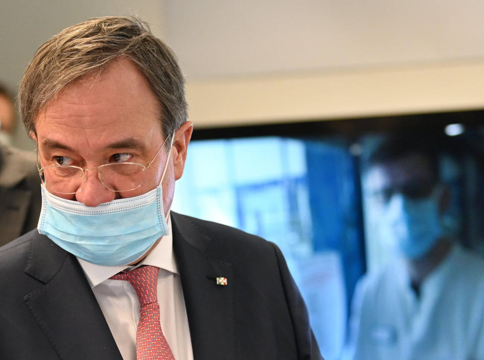 30 March 2020, North Rhine-Westphalia, Aachen: Armin Laschet (CDU), Prime Minister of North Rhine-Westphalia, who is wearing a face mask due to the corona pandemic, follows a treatment in an affiliated hospital during a press meeting at the start of the virtual hospital at the University Hospital RWTH Aachen. Photo: Henning Kaiser/dpa (Photo by Henning Kaiser/picture alliance via Getty Images)