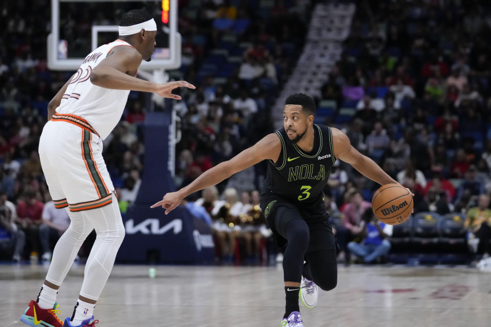 New Orleans Pelicans guard CJ McCollum (3) drives to the lane against San Antonio Spurs guard Malaki Branham (22) in the first half of an NBA basketball game in New Orleans, Friday, Dec. 1, 2023. (AP Photo/Gerald Herbert)