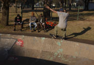 Skateboarder Dallas Oberholzer, 46, rides at the Germiston Lake Skateboard Park, near Johannesburg, Saturday, July 3, 2021. The age-range of competitors in skateboarding's Olympic debut at the Tokyo Games is remarkably broad and 46-year-old Dallas Oberholzer will go wheel-to-wheel with skaters less than half his age. (AP Photo/Denis Farrell)