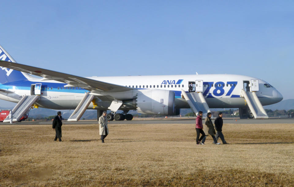 In this photo taken by a passenger and distributed by Japan's Kyodo News, passengers leave an All Nippon Airways Boeing 787 after it made an emergency landing at Takamatsu airport in Takamatsu, Kagawa Prefecture, western Japan, Wednesday, Jan. 16, 2013. ANA said a cockpit message showed battery problems and a burning smell was detected in the cockpit and the cabin, forcing the 787 on a domestic flight to land at the airport. (AP Photo/Kyodo News) JAPAN OUT, MANDATORY CREDIT, NO LICENSING IN CHINA, HONG KONG, JAPAN, SOUTH KOREA AND FRANCE