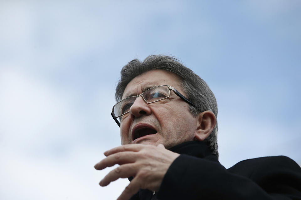 French Left party leader and candidate for the 2017 French presidential election, Jean-Luc Melenchon makes a speech from a barge on the canal de l'Ourcq, in Paris, Monday, April 17, 2017. Melenchon, enjoying a late poll surge, is campaigning on a barge Monday floating through the canals of Paris. (AP Photo/Thibault Camus)