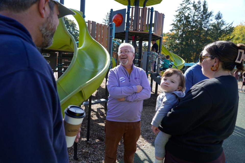 James L. Lathrop, Republican candidate for general treasurer,  introduces himself and his campaign to parents 
Brad and Kirsten Medeiros, with their baby, Rory, of North Kingstown on Sunday.  He was campaigning at the playground at Wilson Park in Wickford.