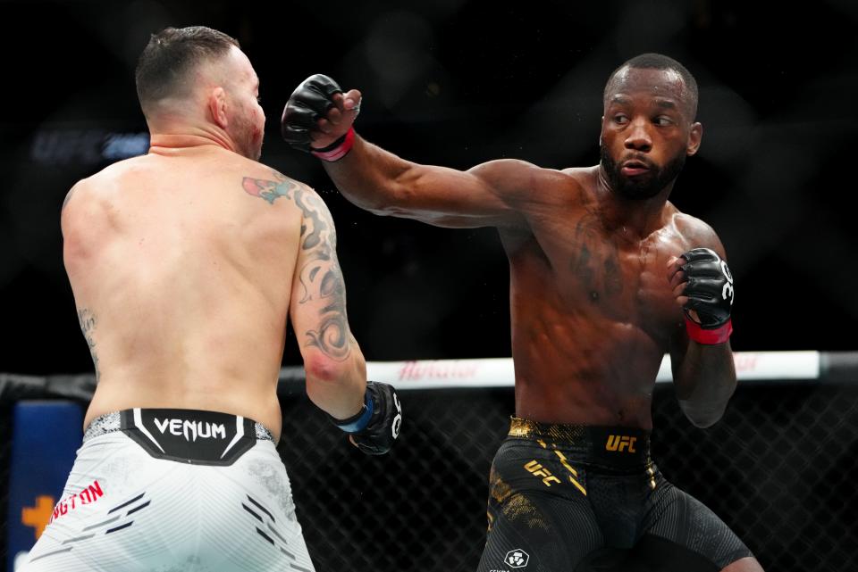 December 16, 2023;  Las Vegas, Nevada, USA;  Leon Edwards (red gloves) fights Colby Covington (blue gloves) during UFC 296 at T-Mobile Arena.  Mandatory Credit: Stephen R. Sylvanie-USA TODAY Sports