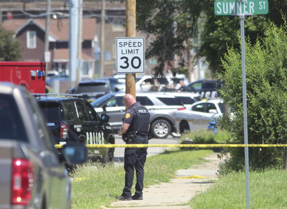 Police secure the scene where two police officers were wounded and a suspect was killed in an exchange of gunfire on Sunday, June 30, 2024, in Waterloo, Iowa. State investigators said Monday, July 1, 2024, said the police were responding to a report of a bicyclist with a gun. (Jeff Reinitz/The Courier via AP)