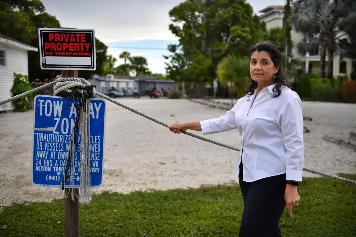 Lourdes Ramirez stands at Beach Road, on Siesta Key, at the site of a proposed 170-room hotel. She is suing the county over approval of the hotel.