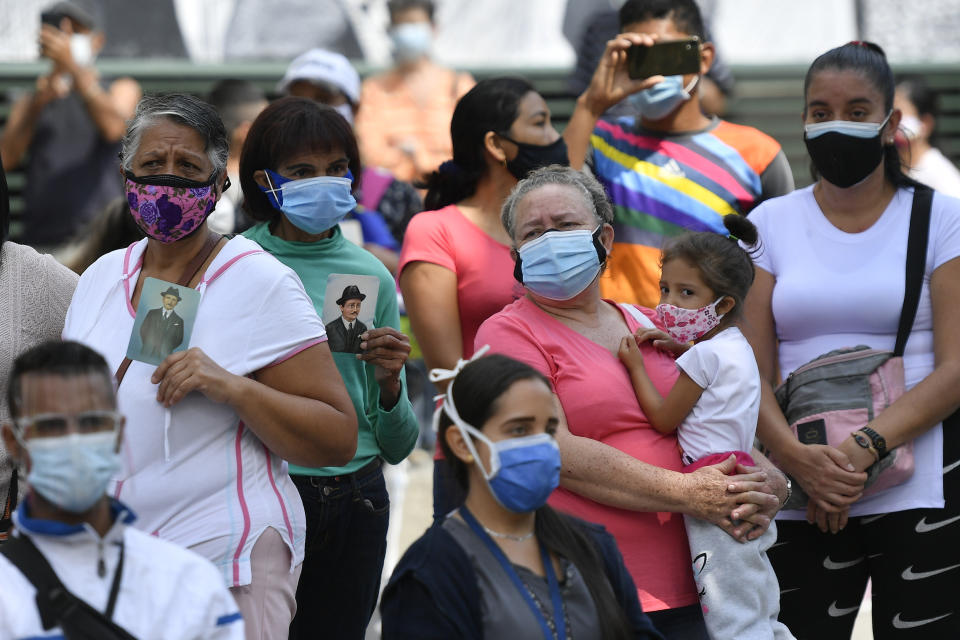 People gather outside the church associated with the remains of Venezuelan Dr. Jose Gregorio Hernandez, on the day of his Beatification ceremony in Caracas, Venezuela, Friday, April 30, 2021. Known as the "doctor of the poor, Hernandez will be beatified Friday by the Catholic church, a step towards sainthood. (AP Photo/Matias Delacroix)