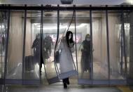 People wearing masks walk through an underground passage to the subway in Beijing