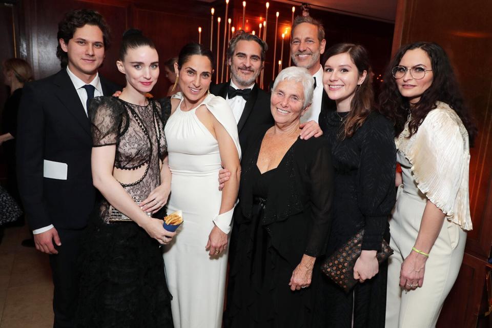 Rooney Mara hangs out with boyfriend Joaquin Phoenix's family, including his sister Summer and Rain, and mother Arlyn Phoenix at the Warner Bros. Oscar Party. 