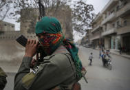 FILE -- In this file photo taken on Wednesday, March 28, 2018, a member of the Kurdish internal security forces holds his weapon during a patrol in Manbij, north Syria. The planned U.S. troop withdrawal opens a void in the north and east of Syria, and the conflicts and rivalries among all the powers in the Middle East are converging to fill it. (AP Photo/Hussein Malla, File)