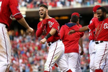 Bryce Harper celebrates with teammates after hitting a walk-off home run against the Braves on Saturday. (Getty)