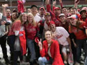 Jayme Hoskins, front, wife of Philadelphia Phillies first baseman Rhys Hoskins, poses with fans at Game 4 of the baseball World Series between the Phillies and the Houston Astros on Wednesday. Nov. 2, 2022, in Philadelphia. Hoskins tweeted she would buy fans beer before the game at Section 104 of the stadium. She paid for about 100 beers. (AP Photo/Daniel Gelston)