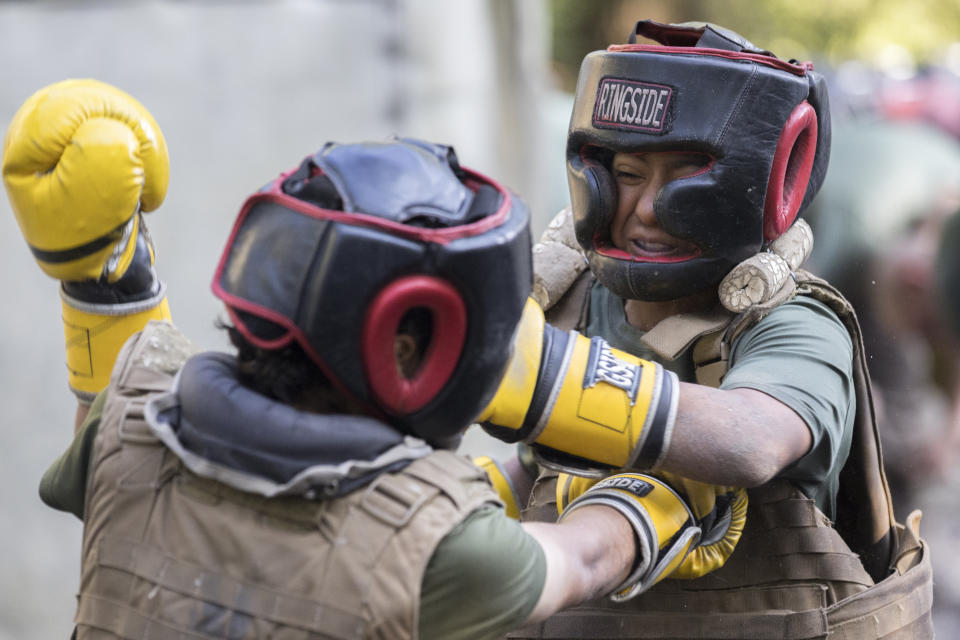 Two female U.S. Marine Corps recruits, dressed in sparring headgear and flak jackets, take part in a hand-to-hand combat drill during a portion of training known as the Crucible at the Marine Corps Recruit Depot, Thursday, June 29, 2023, in Parris Island, S.C. (AP Photo/Stephen B. Morton)