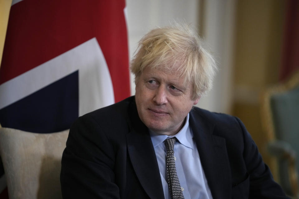 British Prime Minister Boris Johnson listens to Polish Prime Minister Mateusz Morawiecki at the start of their meeting inside 10 Downing Street, in London, Friday, Nov. 26, 2021. (AP Photo/Matt Dunham, Pool)